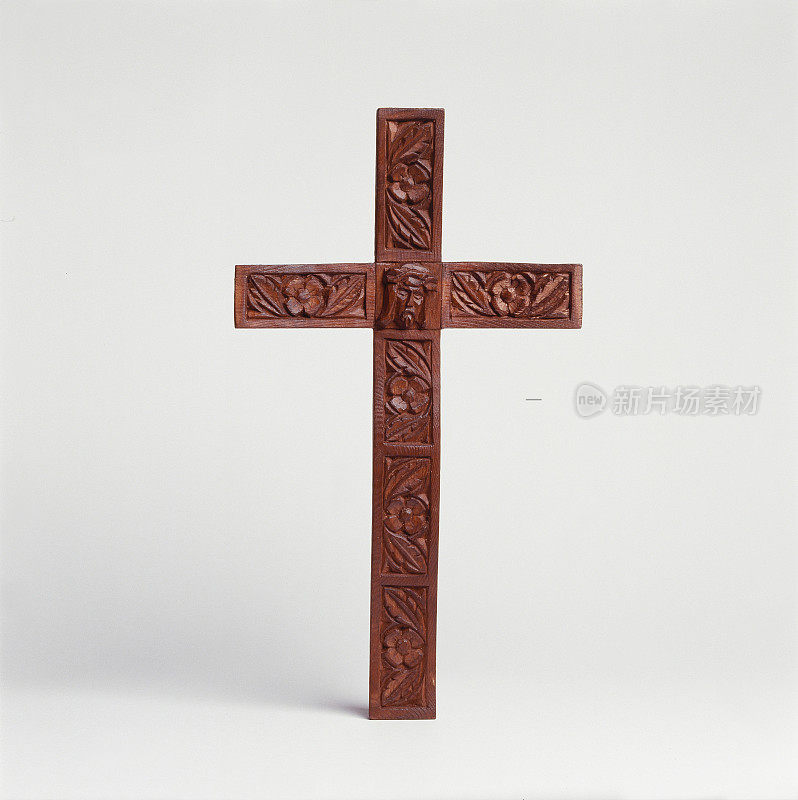 Crucifix carved in wood in white background